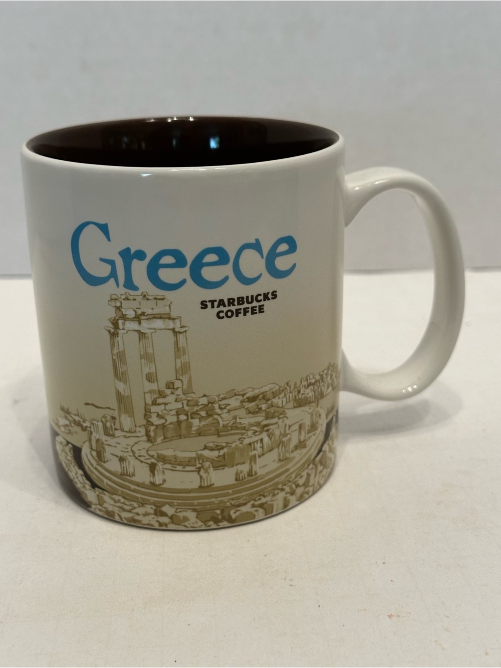 Starbucks White Mug with Blue Greece Lettering and Brown Interior